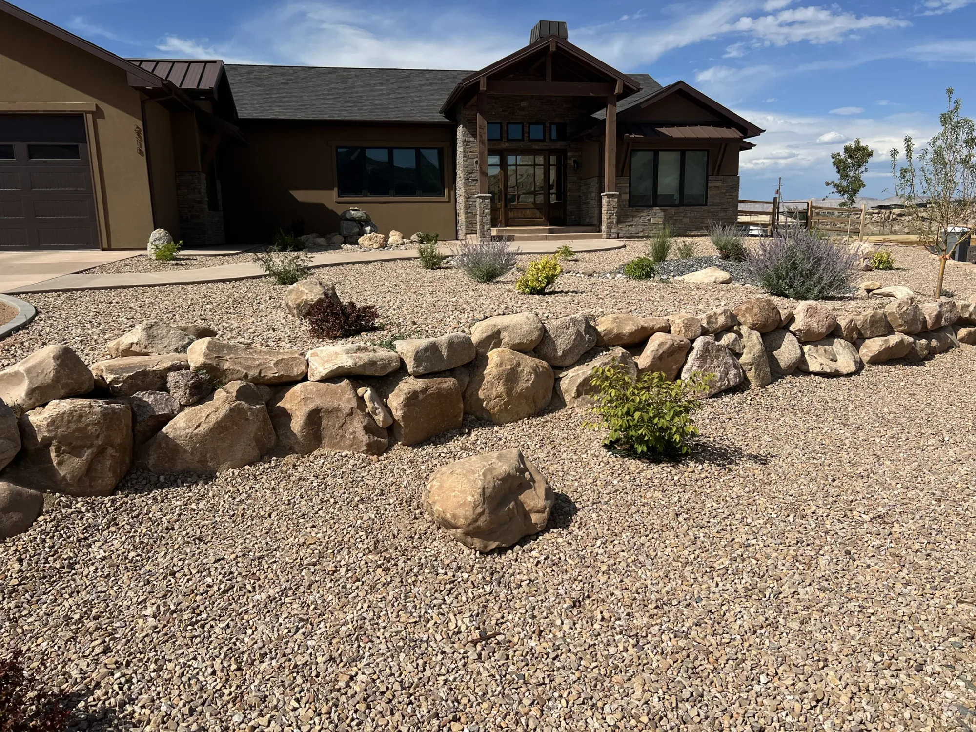 Completed xeriscape installation with layered textures and clean landscape lines.